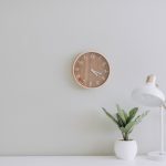 white desk lamp beside green plant